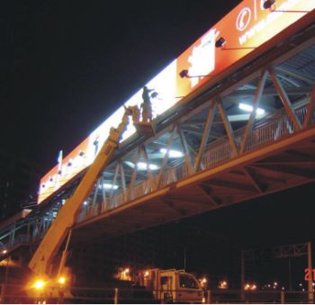 Night installation of billboard using skylift